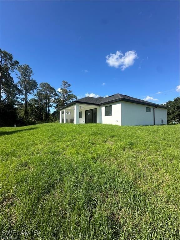 178 Mcarthur Blvd, Lehigh Acres, FL 33974 - back of property featuring stucco siding