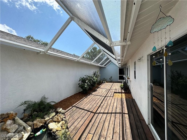 wooden deck featuring a lanai and a patio area