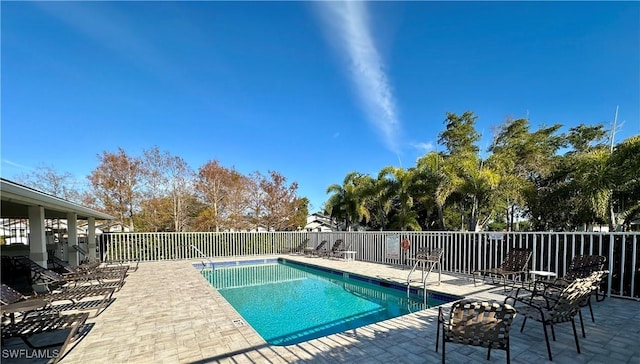 community pool featuring a patio and fence