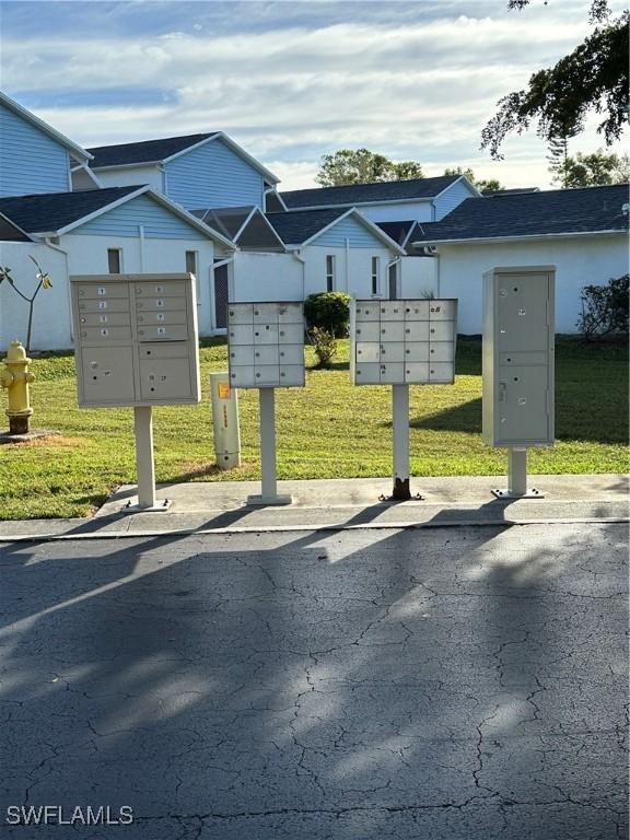 view of property's community with a yard and mail area