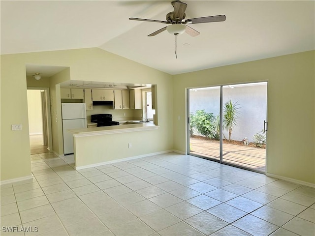 unfurnished living room featuring a ceiling fan, baseboards, vaulted ceiling, and light tile patterned floors