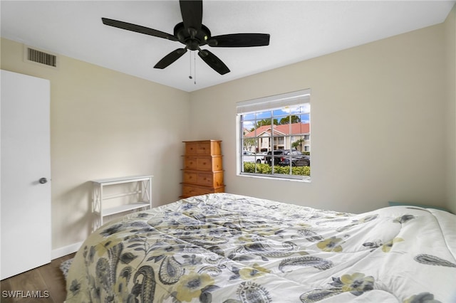 bedroom with wood finished floors, baseboards, and a ceiling fan