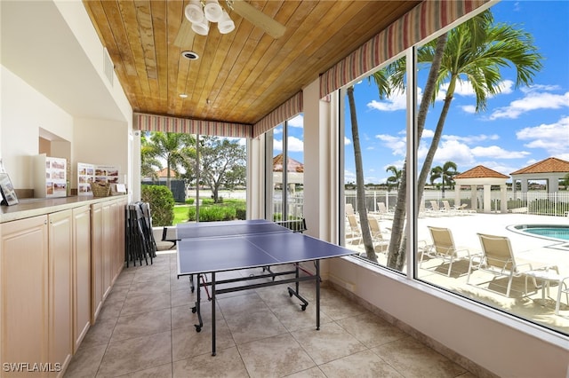rec room featuring wood ceiling, a ceiling fan, and light tile patterned flooring