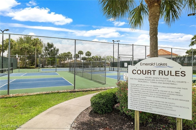 view of tennis court with fence