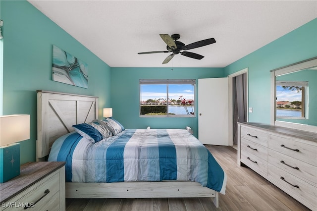 bedroom with light wood-style floors and a ceiling fan