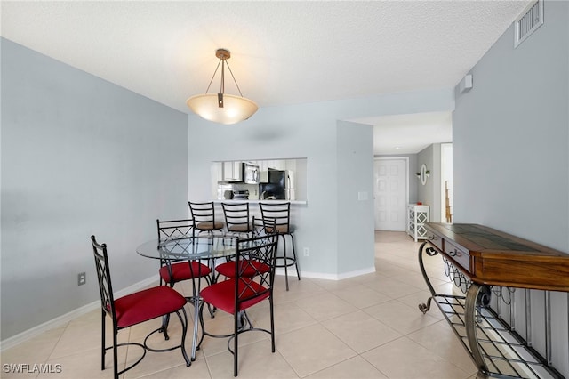dining area with light tile patterned flooring and baseboards