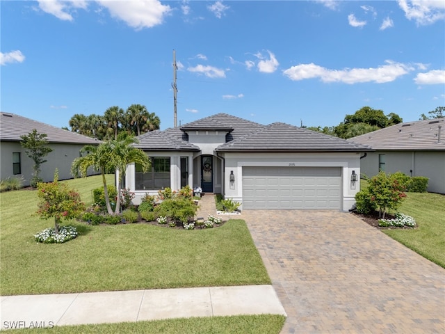 2076 Yellowfin Cir, Naples, FL 34114 - view of front of home featuring a garage, a tiled roof, stucco siding, a front yard, and driveway