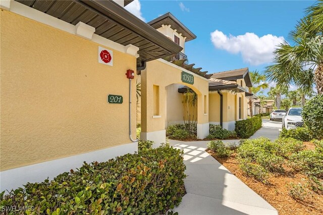 property entrance with stucco siding