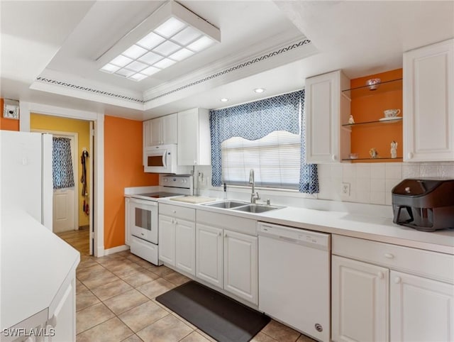 kitchen featuring a sink, white appliances, white cabinetry, a raised ceiling, and backsplash