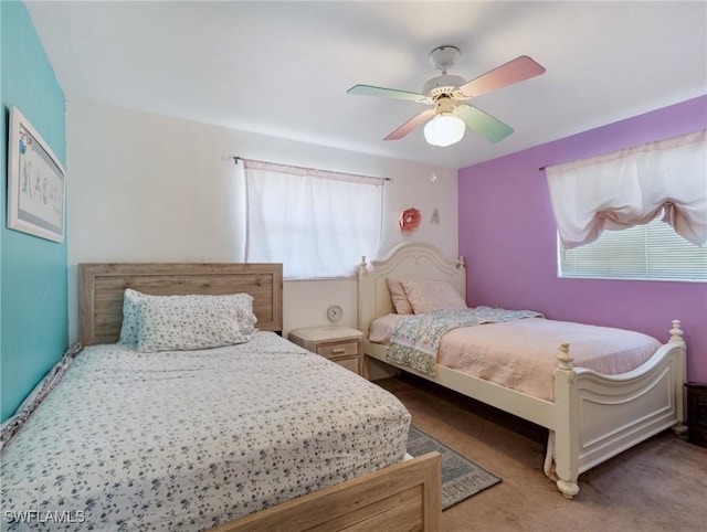 bedroom with ceiling fan and carpet floors
