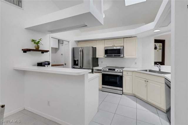 kitchen with a sink, stainless steel appliances, light tile patterned flooring, visible vents, and light countertops