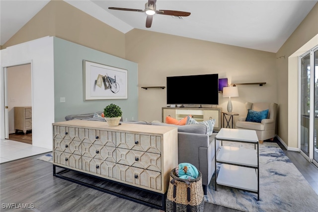 living room with baseboards, vaulted ceiling, wood finished floors, and a ceiling fan