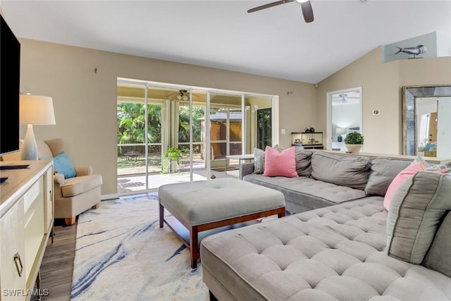 living room featuring light wood-style floors, baseboards, lofted ceiling, and a ceiling fan