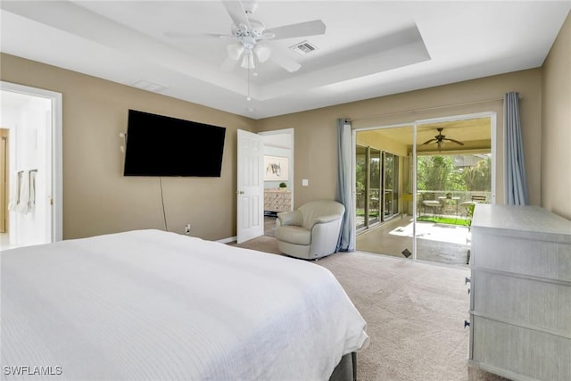 bedroom featuring a ceiling fan, carpet, visible vents, a raised ceiling, and access to exterior