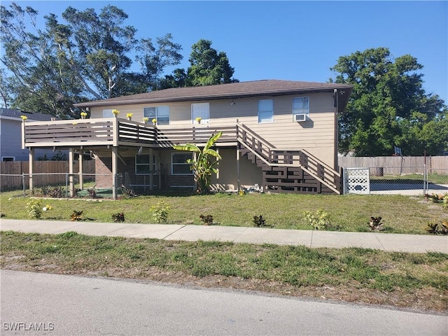 view of front of property featuring stairway, a front lawn, and fence