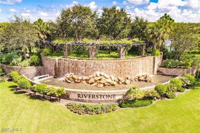 3454 Pacific Dr, Naples, FL 34119 - community / neighborhood sign featuring a lawn and view of scattered trees