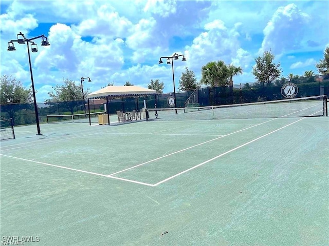 view of tennis court with fence