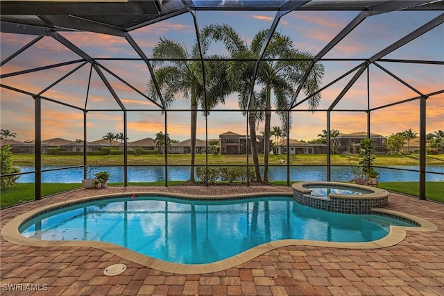 3454 Pacific Dr, Naples, FL 34119 - view of pool with a patio, glass enclosure, a pool with connected hot tub, a water view, and a lawn