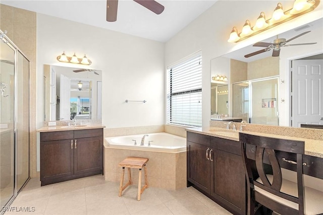 3454 Pacific Dr, Naples, FL 34119 - bathroom with ceiling fan, a stall shower, a garden tub, tile patterned flooring, and two vanities