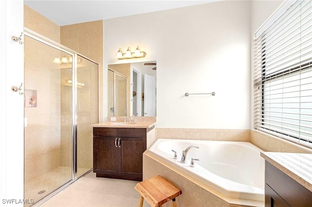3454 Pacific Dr, Naples, FL 34119 - bathroom featuring a stall shower, healthy amount of natural light, a garden tub, and vanity
