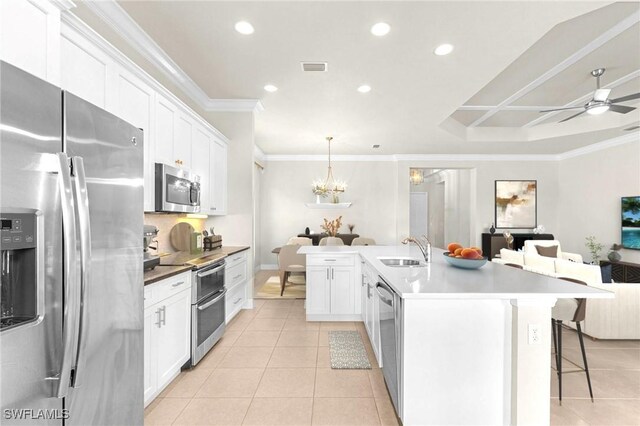 3454 Pacific Dr, Naples, FL 34119 - kitchen with appliances with stainless steel finishes, open floor plan, light tile patterned floors, a sink, and a kitchen breakfast bar