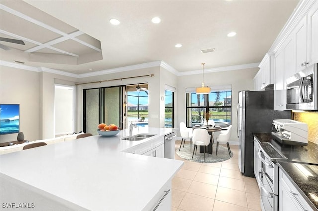 3454 Pacific Dr, Naples, FL 34119 - kitchen featuring appliances with stainless steel finishes, a sink, light tile patterned floors, recessed lighting, and white cabinetry