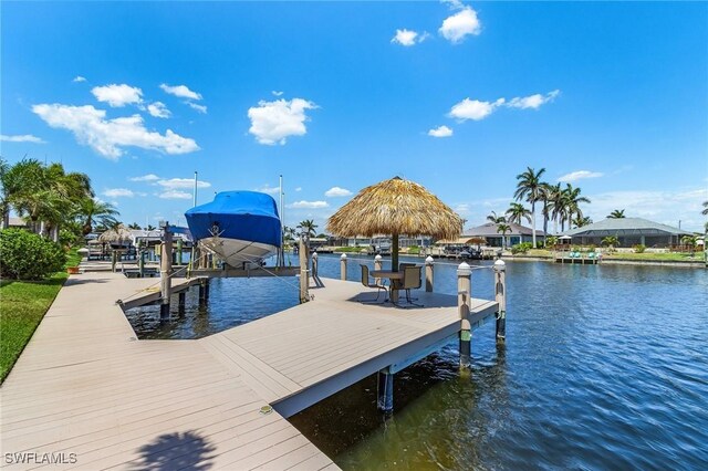 dock featuring boat lift and a water view