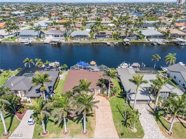 aerial view of residential area featuring a large body of water