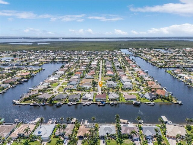 aerial view of property's location featuring nearby suburban area and a nearby body of water