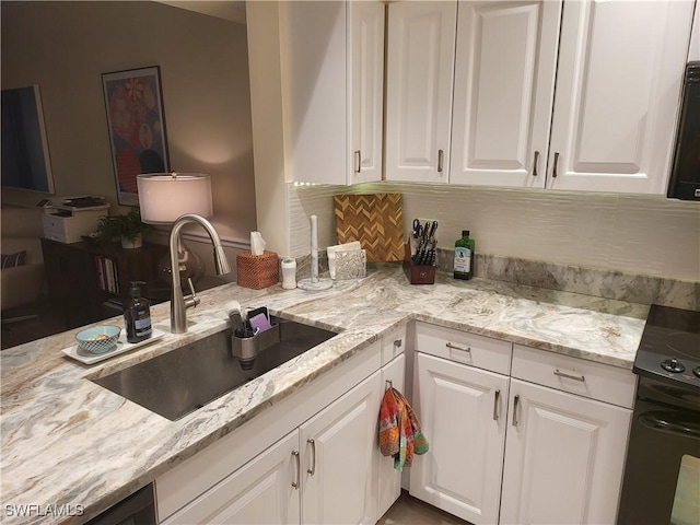 512 Sugar Pine Ln Unit 512, Naples, FL 34108 - kitchen featuring white cabinetry, light stone counters, black electric range oven, and a sink