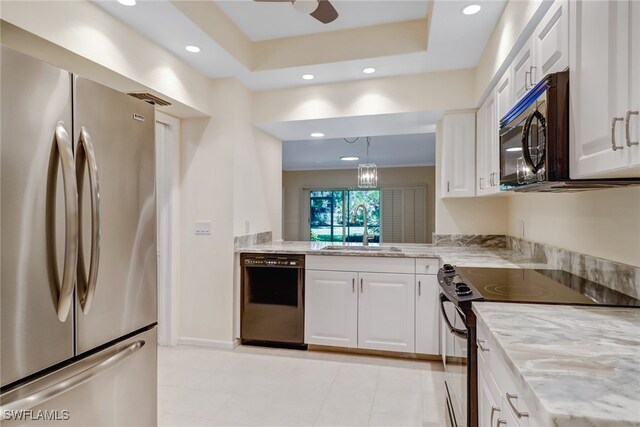 512 Sugar Pine Ln Unit 512, Naples, FL 34108 - kitchen with a sink, light stone counters, black appliances, recessed lighting, and white cabinetry