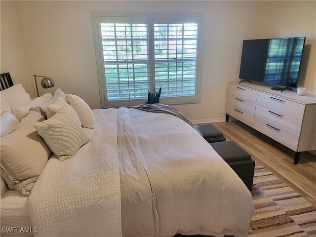512 Sugar Pine Ln Unit 512, Naples, FL 34108 - bedroom with baseboards and light wood finished floors