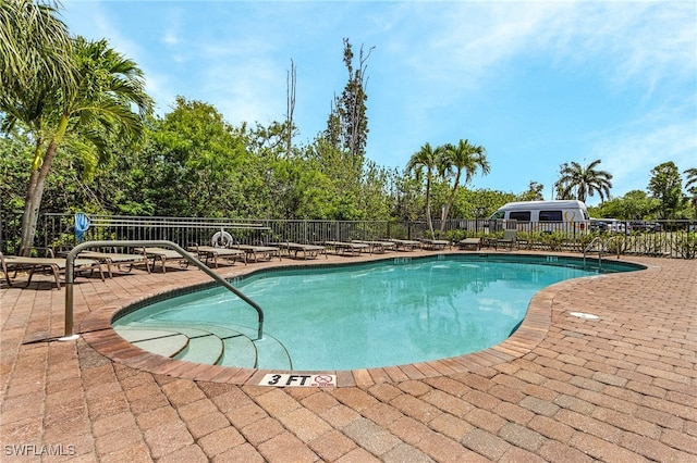 pool with fence and a patio