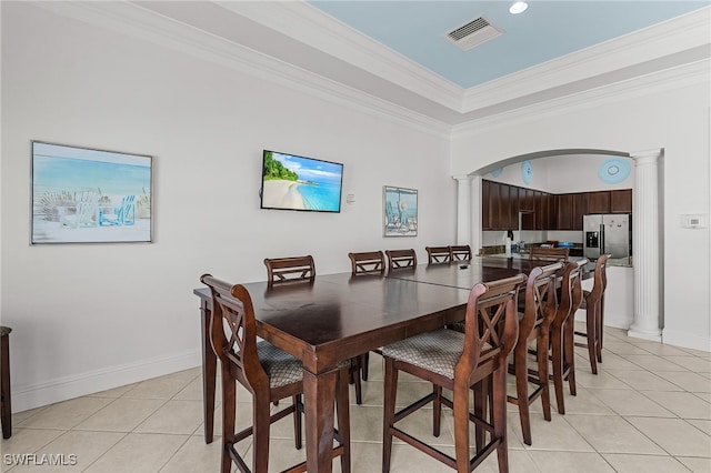 dining area with ornamental molding, light tile patterned floors, visible vents, and ornate columns