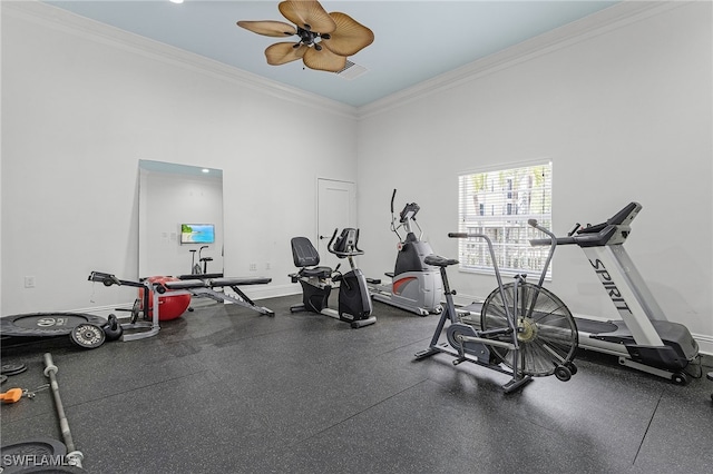 exercise area featuring ornamental molding, baseboards, and visible vents