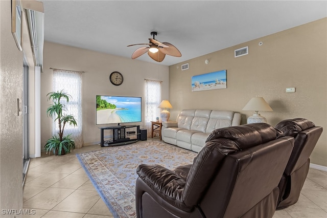 living room featuring a ceiling fan, a wealth of natural light, visible vents, and light tile patterned flooring