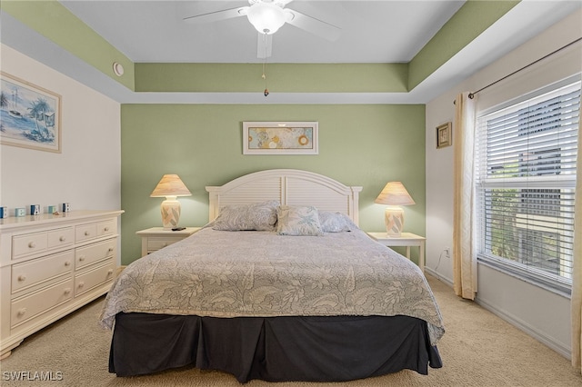 bedroom with baseboards, light carpet, and ceiling fan