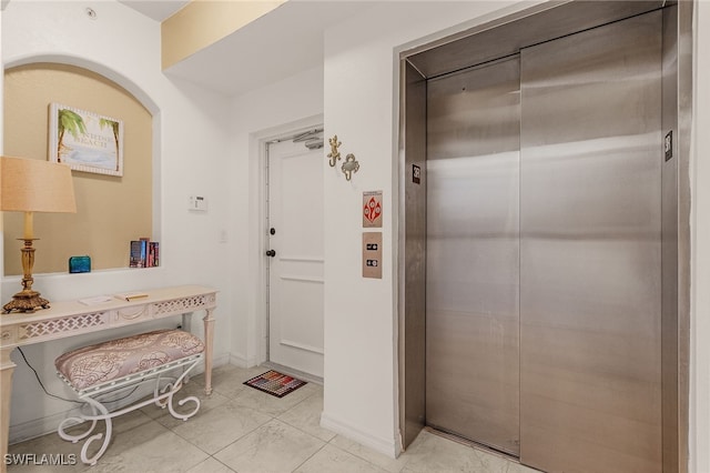 interior space with elevator and arched walkways