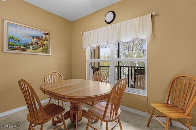 dining area with light tile patterned floors and baseboards