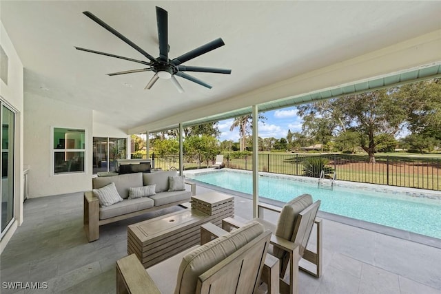 view of swimming pool featuring a ceiling fan, a fenced in pool, outdoor lounge area, fence, and a patio