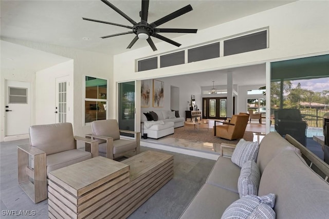 living room featuring plenty of natural light and ceiling fan