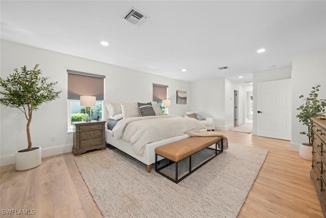 bedroom featuring light wood-type flooring, visible vents, and recessed lighting