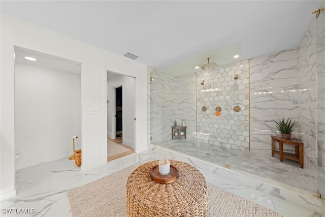 interior space featuring marble finish floor, walk in shower, and visible vents
