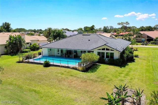 outdoor pool featuring a residential view and a lawn