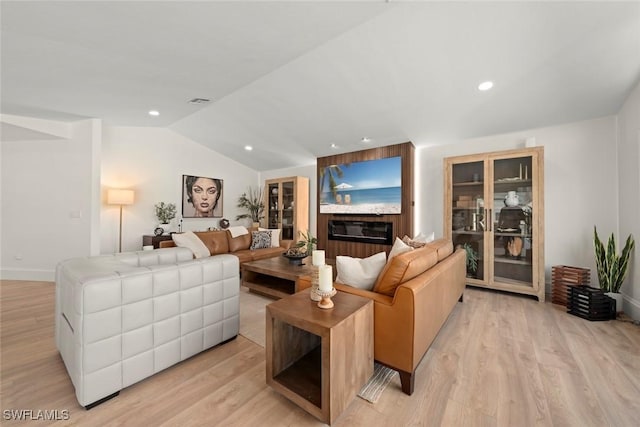 living area featuring lofted ceiling, recessed lighting, baseboards, and light wood-type flooring