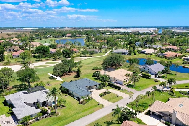 bird's eye view with golf course view, a water view, and a residential view