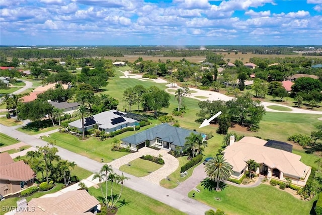 drone / aerial view with golf course view and a residential view