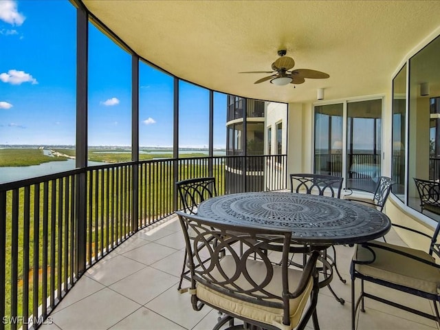 1050 Borghese Ln Unit 1804, Naples, FL 34114 - sunroom featuring outdoor dining area, a water view, and ceiling fan