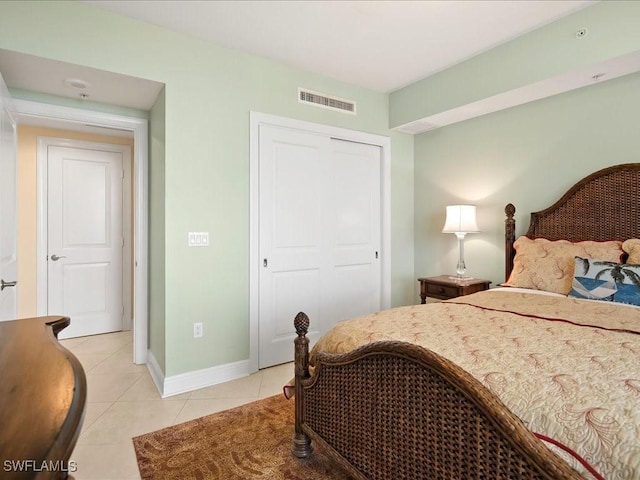 1050 Borghese Ln Unit 1804, Naples, FL 34114 - bedroom featuring baseboards, a closet, visible vents, and light tile patterned flooring