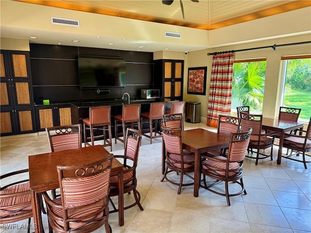 1050 Borghese Ln Unit 1804, Naples, FL 34114 - dining area featuring a tray ceiling and visible vents